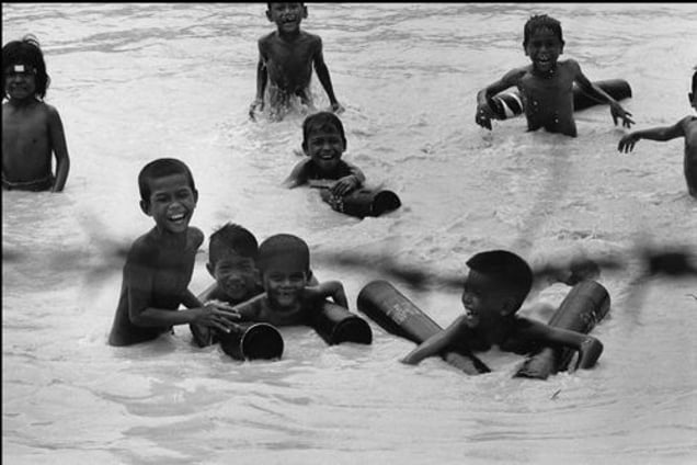Cambodia. Children swimming in the Mekong. 1974. From the book "War Photographer: Between Shadow and Light" © Christine Spengler