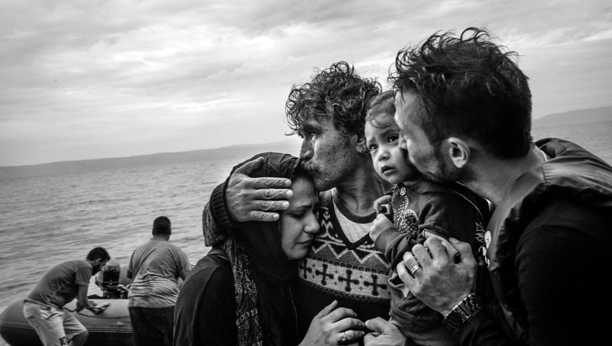 A Syrian family weeps tears of joy after reaching, on a rubber boat from Turkey, the village of Skala Sykaminias located on the northeastern Greek island of Lesbos, on October 10, 2015.