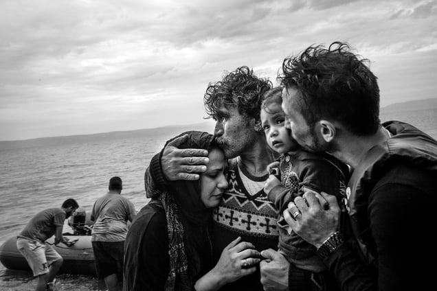 A Syrian family weeps tears of joy after reaching, on a rubber boat from Turkey, the village of Skala Sykaminias located on the northeastern Greek island of Lesbos, on October 10, 2015.