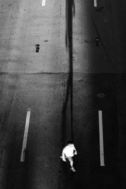 man shadows road, no cars